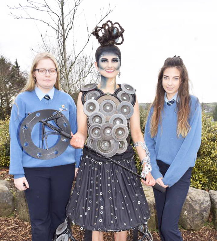 Two students with a girl in costume