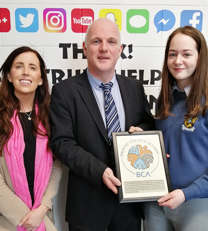 Principal, teacher and learner holding an award