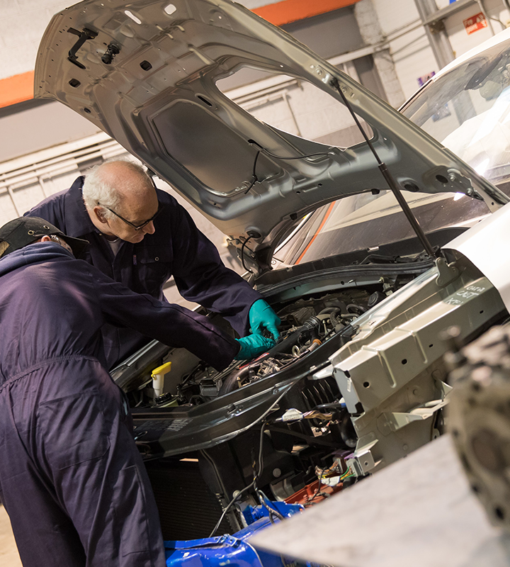 Image of mechanic students looking in a car bonnet