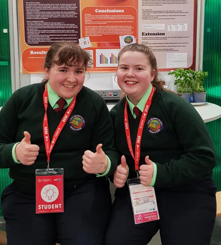 Two female students with thumbs up