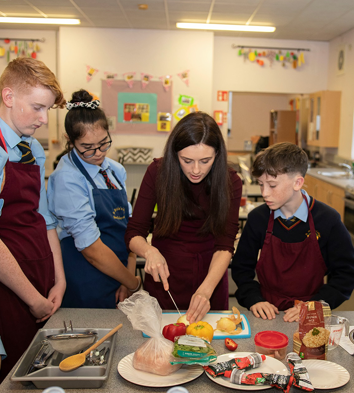 A teacher demonstrating cooking techniques