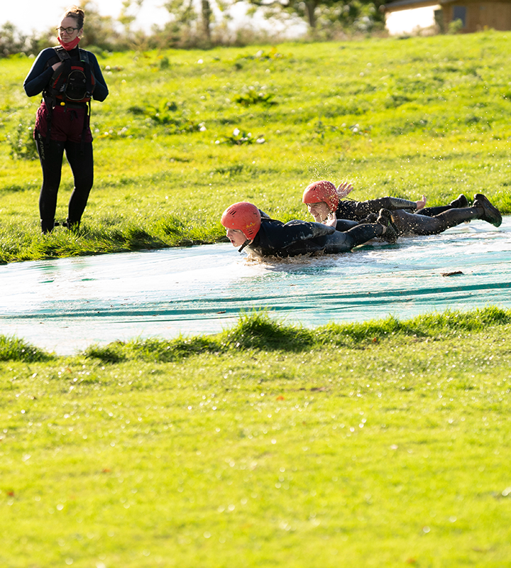 Image of people sliding down a hill