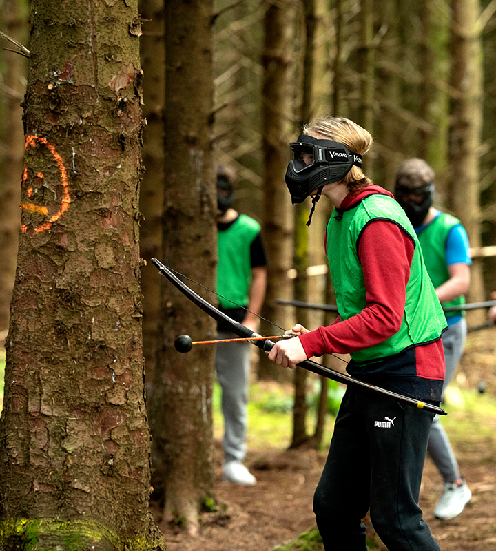 Image of people taking part in archery 