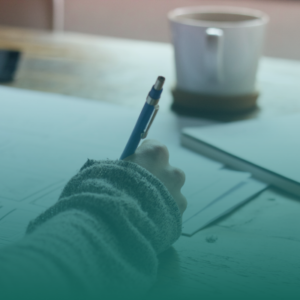 a person writing on a notepad